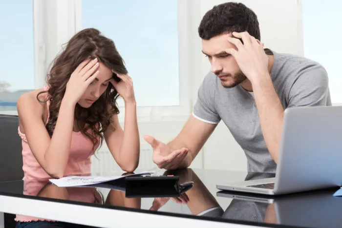 couple looking at Raymond James Financial statement with hidden fees