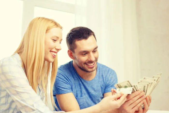couple holding settlement cash