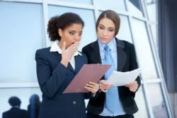 Employees looking at expense report