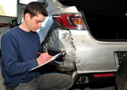 Insurance expert filing claim at car accident