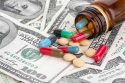 Multicolored pills on cash