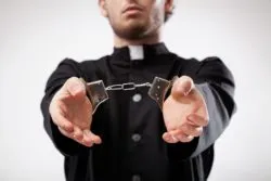 Priest in handcuffs