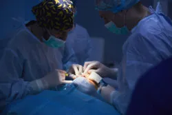 Surgeons operating in dark room