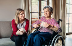Two women work on some knitting.