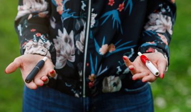 woman holding ecigarettes