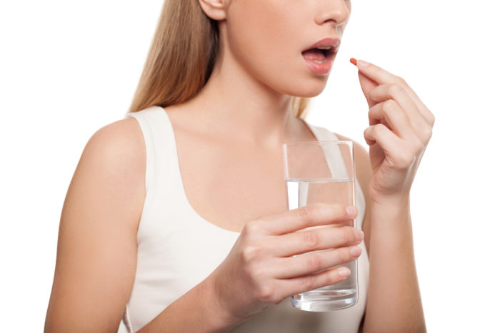 woman taking FoodState vitamin
