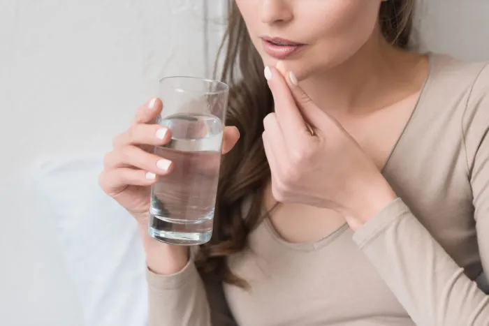 woman taking foodstate vitamin supplement