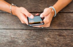 Woman's hand holding a cell phone