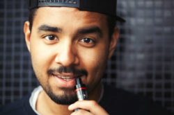 Young man smoking e cigarette