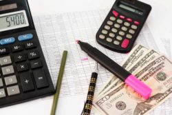 Cash with calculators and ledger