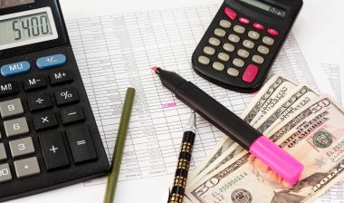 Cash with calculators and ledger