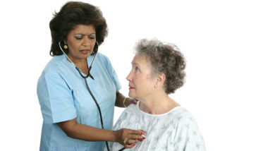 Doctor checking woman's heart