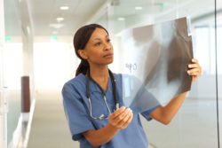 A doctor examines a chest X-ray.