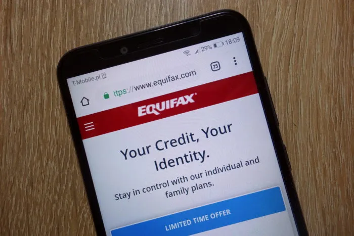 equifax website open on smartphone - equifax data breach settlement - equifax class action lawsuit