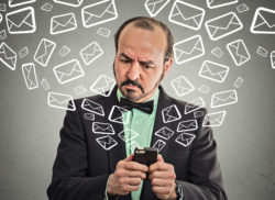 A man deals with a bunch of text messages.