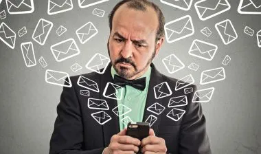 A man deals with a bunch of text messages.