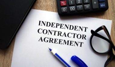 Independent contractor agreement with pen, glasses, calculator