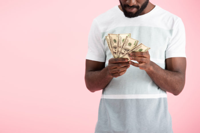 man counting money from settlement check