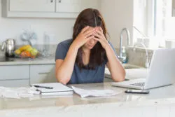 Stressed woman looking at bills