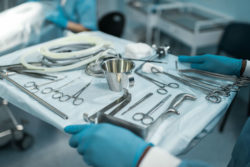 Surgeon holding tray of tools