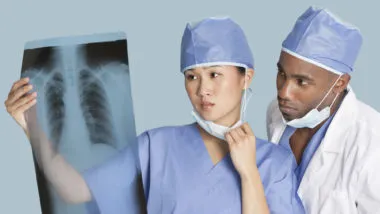 Surgeons looking at chest x-ray