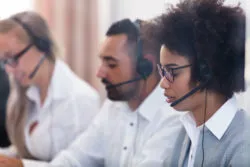 Telemarketers work in a phone bank.
