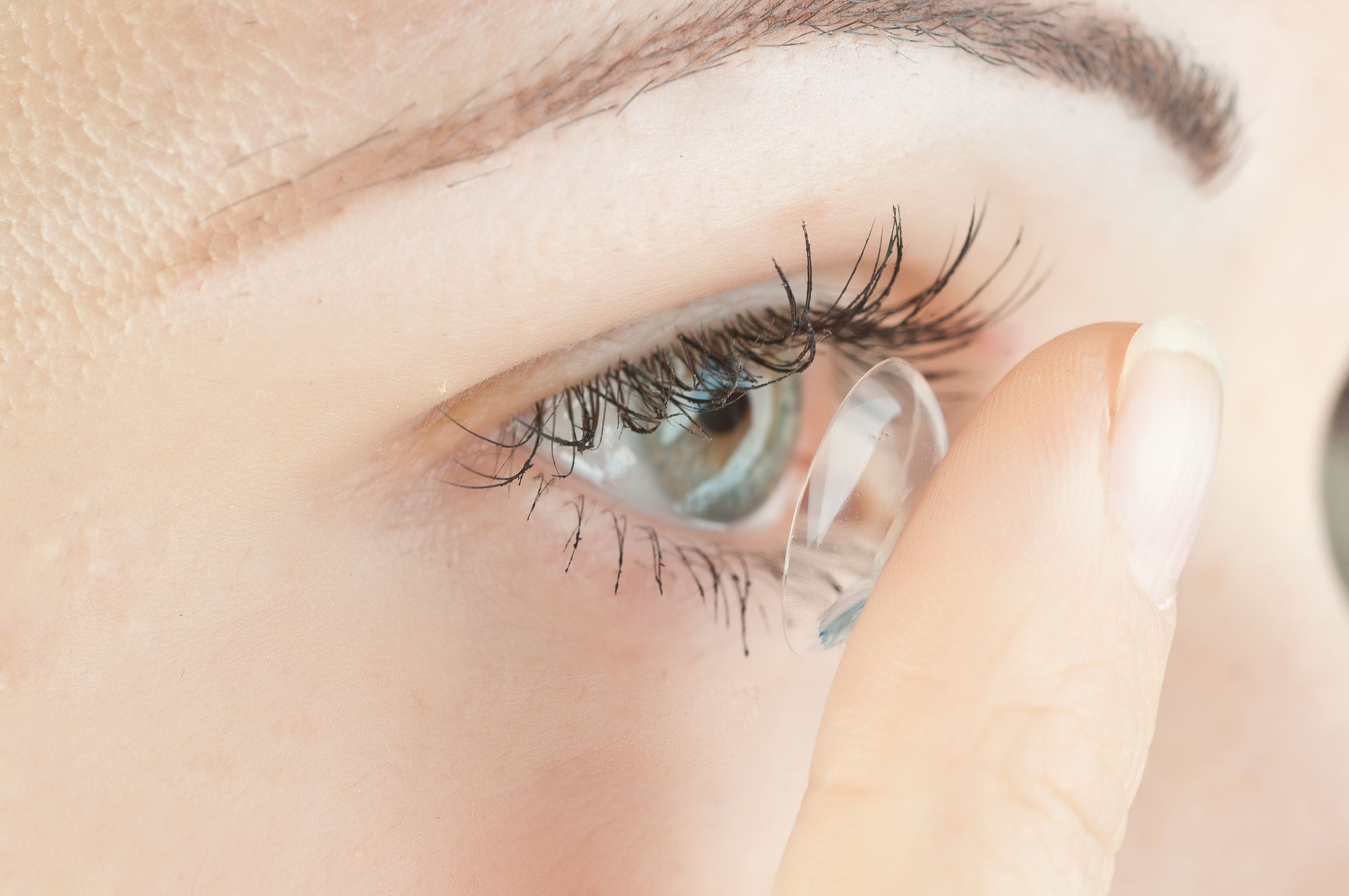 woman applying contact lens