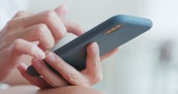 woman hands holding cell phone