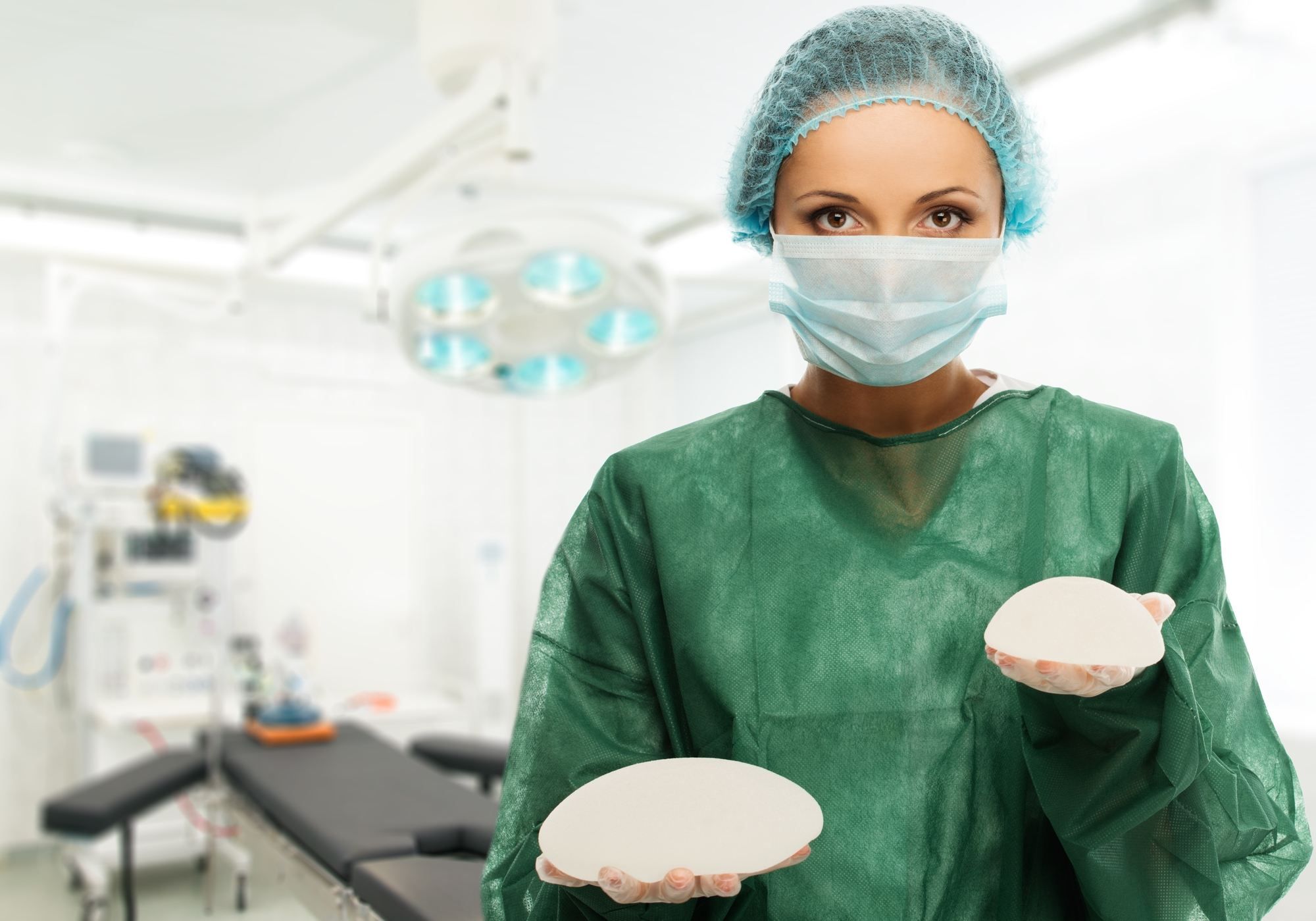 Plastic surgeon woman holding different size silicone breast implants