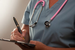 A woman wearing medical scrubs