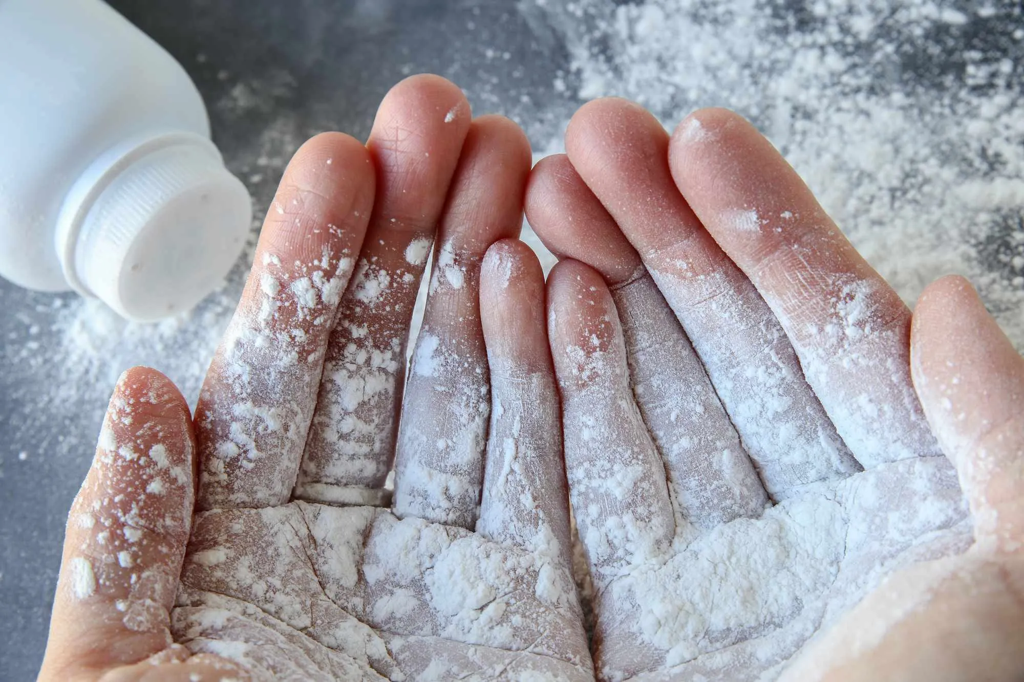 Talcum powder on two hands