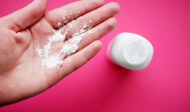 Johnson & Johnson baby powder on woman's hand