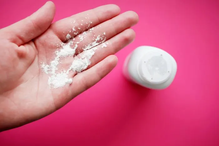 Johnson & Johnson baby powder on woman's hand