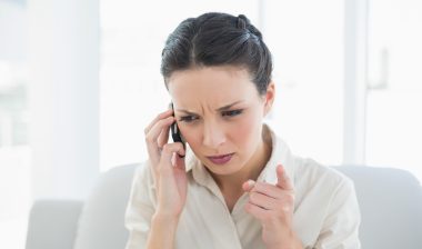 Frowning stylish brunette businesswoman making a phone call