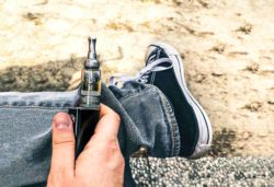 Ecigarette with young person's shoe