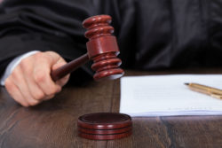 A judge hits a gavel in court.