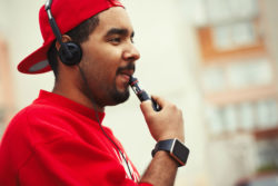 A man uses an e-cigarette.