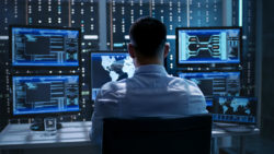A technician monitors data security.