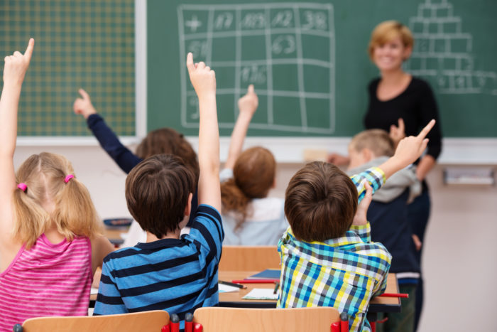 teacher in classroom setting with students