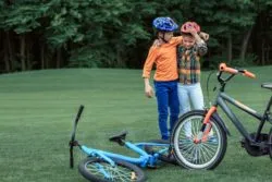 two boys wearing bike helmets