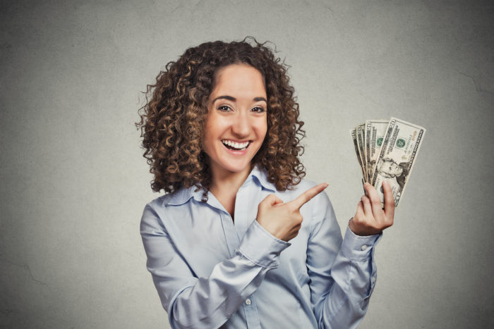 woman holding money from an FTC refund check