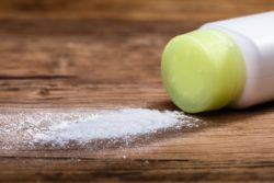 Close-up Of Spilled Talcum Powder On Wooden Desk