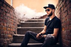 Vaper with beard in sunglasses