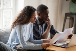 A couple is puzzled by a letter.