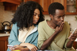 A couple reads a text message.