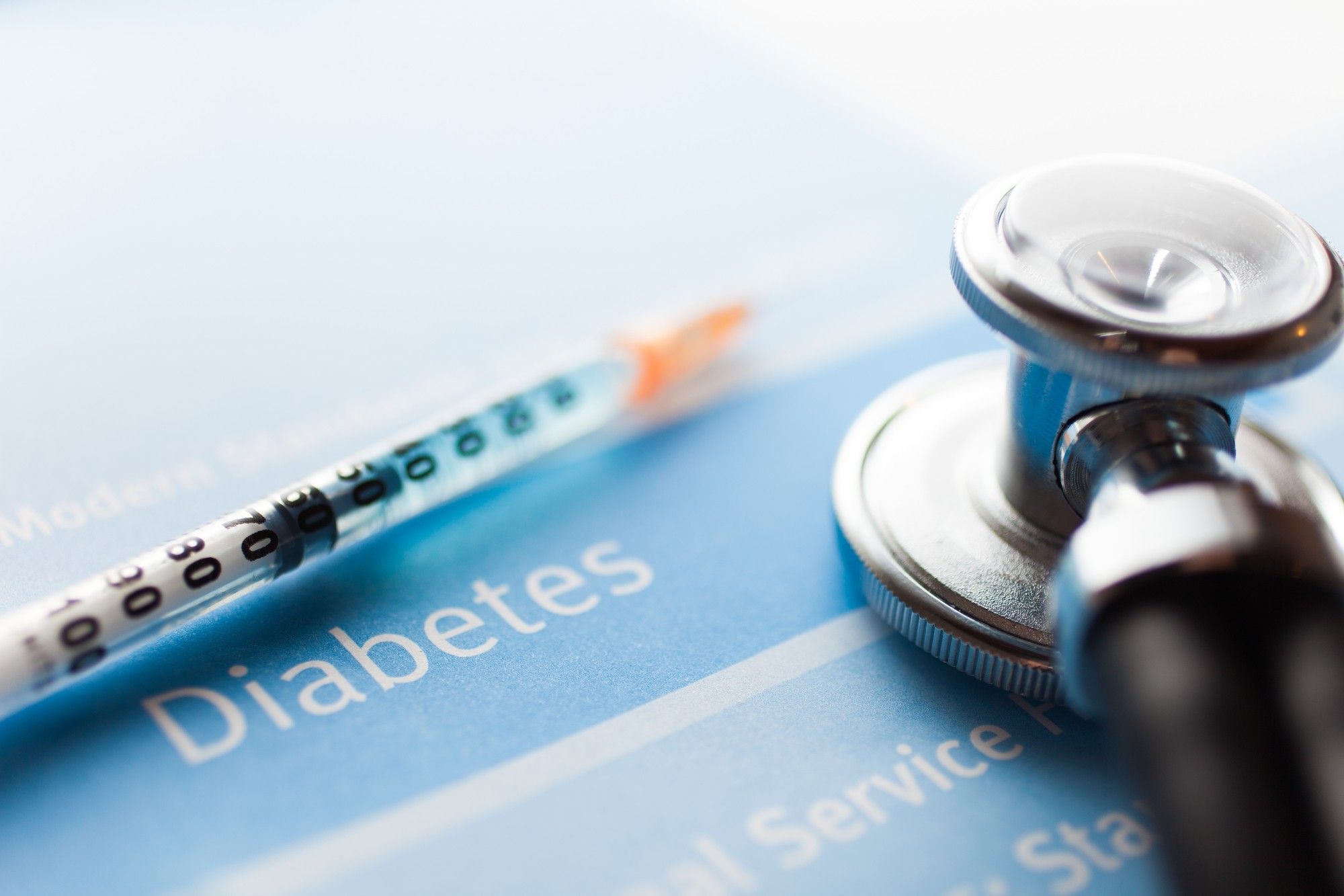 Diabetes syringe on blue
