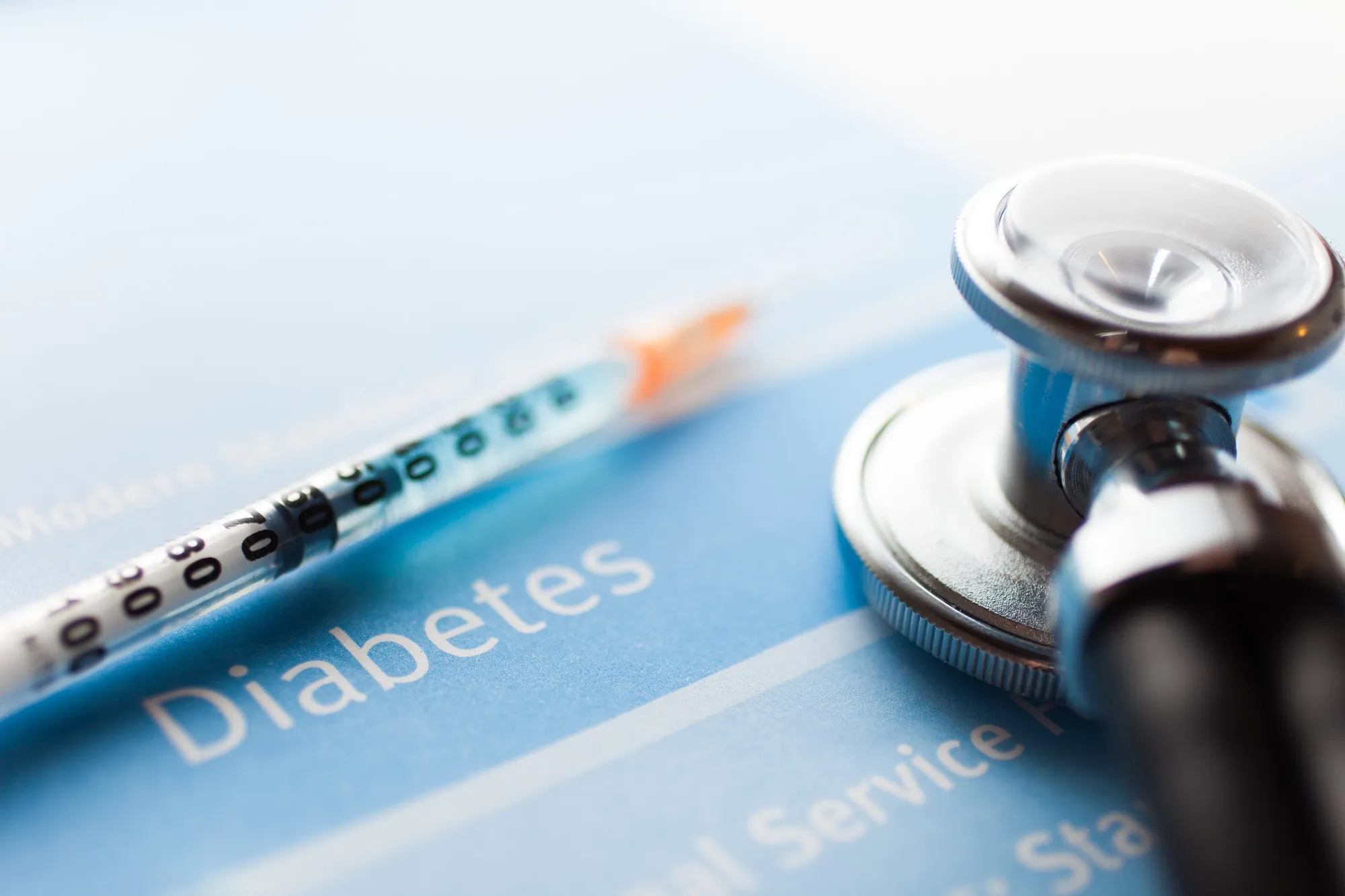 Diabetes syringe on blue