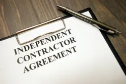 Independent contractor agreement on clipboard