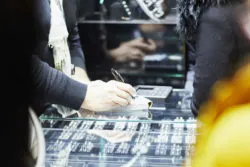 Jewelry store worker selling rings