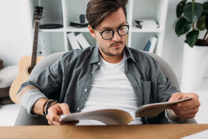 man reading Reader's Digest magazine